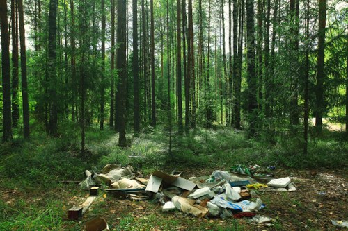 Skilled workers managing builders waste clearance on site