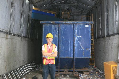 Inspector examining waste containers and recording findings